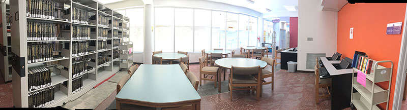 wide angle of albizu university with tables and book shelves