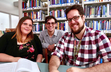 students smiling at Albizu university library